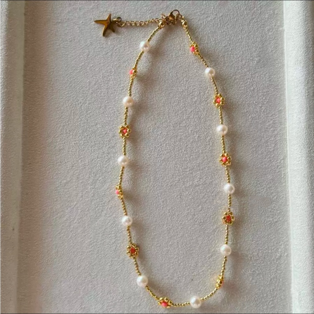 beaded necklace with pearls and pink flower-shaped accents